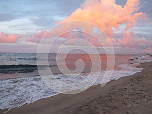 Pink clouds at sunset on the beach