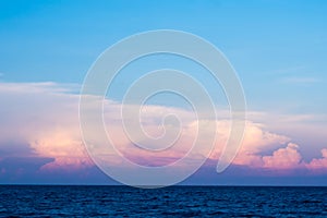 Pink clouds and sunset sky over sea