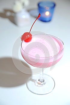 Pink cocktail with cherry