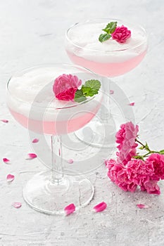 Pink cocktail with rose flowers