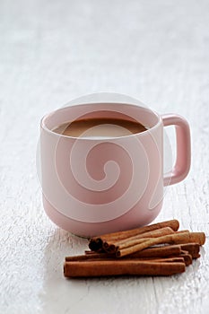 Pink coffee cup with cinnamon stick