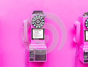 Pink coin payphone on pink wall