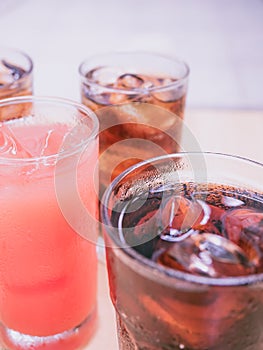 pink color from cool fruit juice and ice with soft focus sparkling water (foreground and background) for summer and fresh