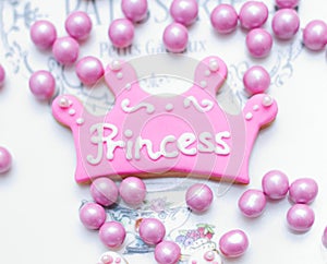 Pink color crown shaped Cookie with princess written on it with white fondant