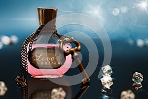 Love potion in a bottle with chain and key around the bottle photo