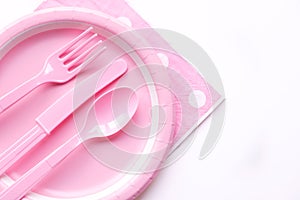 Pink color paper plate with plastic spoon, fork and knife