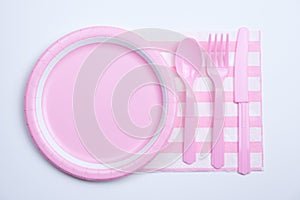 Pink color paper plate with plastic spoon, fork and knife