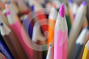 Pink color pencil standing out from the crowd concept