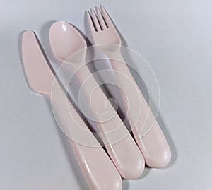 Pink color of spoon, fork and knife cutlery set