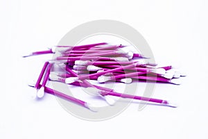 Pink colored cotton coated ear buds or Q-tips isolated on white.