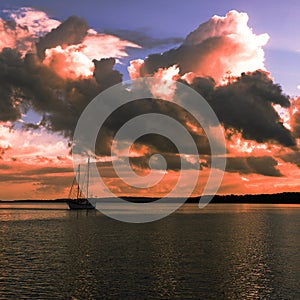 Pink colored cumulonimbus cloud, sunset seascape.