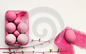 Pink colored easter eggs in pink box, with pink decoration, on w