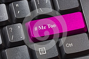 Pink colored Me Too button on black computer keyboard. Sexual harassment concept.