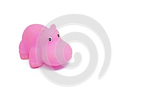 Pink colored plastic hippopotamus toy isolated on white background