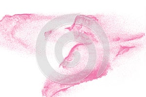 Pink colored sand splash against  white background