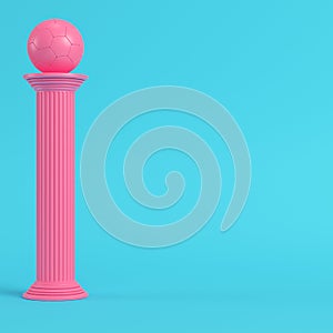 Pink column with soccer ball on bright blue background in pastel