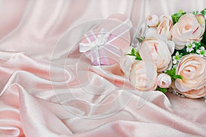 Pink composition with flowers and gift box