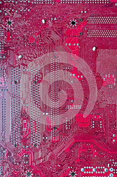 Pink computer circuit board. Hardware components. Close-up, background.
