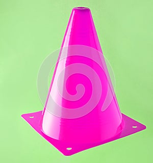 Pink cone, road barrier isolated on a blue background.