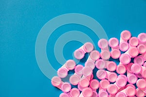 Pink contact lens cases on blue background with copy space