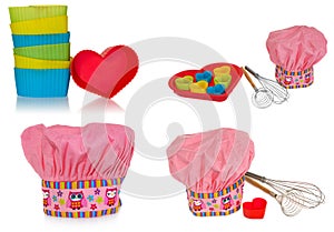 Pink cooking hat, with multi-colored pattern, hearts, flowers and owls. Hearts molds for cookies in red. Whisk to froth