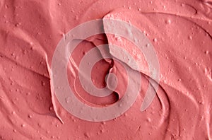 Pink cosmetic clay facial mask, cream texture close up, selective focus.