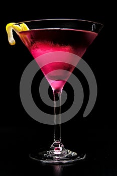 Pink cosmopolitan cocktail isolated on black