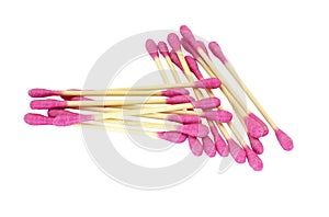 Pink cotton ear swabs highlighted on a white