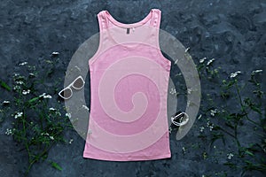 Pink cotton tank top mockup on dark background Blank plain t-shirt template for creative design Female summer sunglasses