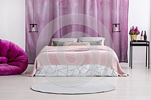 Pink coverlet on bed photo