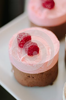 Pink cream cake with berries in restaurant.