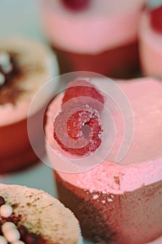 Pink cream cake with berries in restaurant.