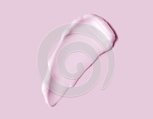 Pink cream smear over pink background. Cosmetic hydration cream smudge of liquid reach face or body cream