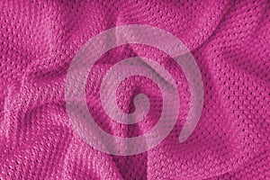 Pink crumpled knitting wool texture background.