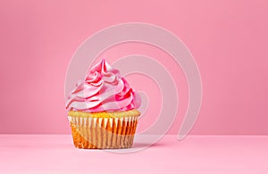 Pink Cupcake with buttercream frosting over a pink background.