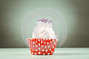 pink cupcake in a red basket/pink cupcake in a red basket, selective focus