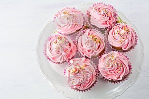 Pink cupcakes on cake stand top view