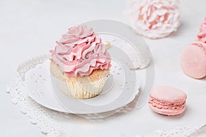 Pink cupcakes with roses and macaroons. Festive and bright. Wedding Celebration concept.