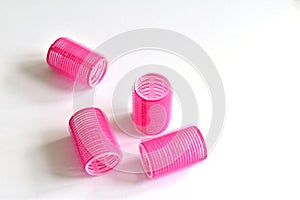 Pink curlers on a white background.