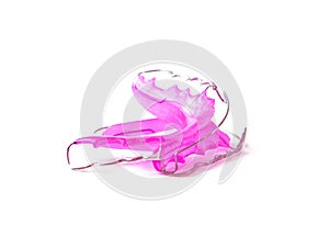 Pink dental retainer orthodontia, isolated on white background photo