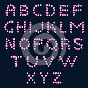 Pink diamond letters alphabet on dark background.