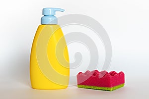 Pink dish wash sponges with bottle of soap. Household cleaning scrub pad. Home cleaning concept.