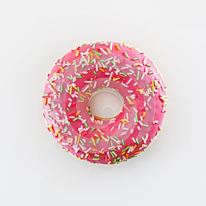 Pink donut against white background