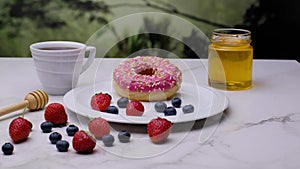 Pink Donut with coffee berries. Close-up 4k video footage, white background