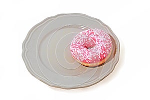 Pink donut on plate. Isolated on white background