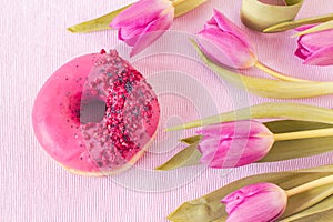 Pink donut with raspberry and sugar sprinkles