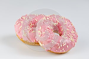 Pink donuts with sprincles on white