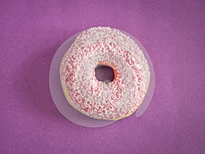 Pink donuts with white sprinkles on purple