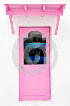 Pink door with sunshade photo