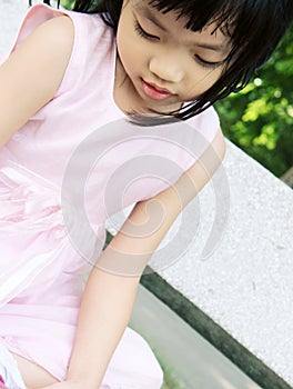 Pink dress girl on bench